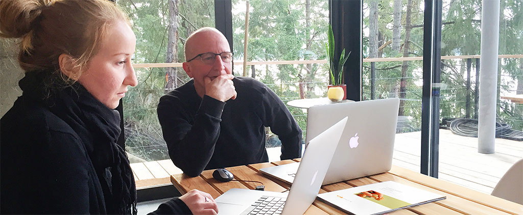 We design marketing communications. Kate Nisbet and Ian McSorley working at the Far & Wide Marketing Galiano Island location
